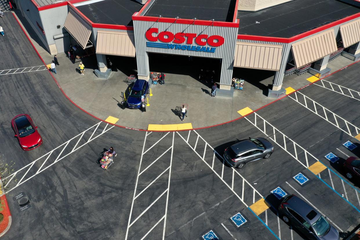 Costco customers leave a Costco store on March 13, 2020 in Richmond, California. Some Americans are stocking up on food, toilet paper, water and other items after the World Health Organization (WHO) declared Coronavirus (COVID-19) a pandemic.