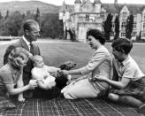 <p>Queen Elizabeth, Prince Philip, Prince Charles, Princess Anne, and Prince Andrew all lavish attention on a corgi.</p>