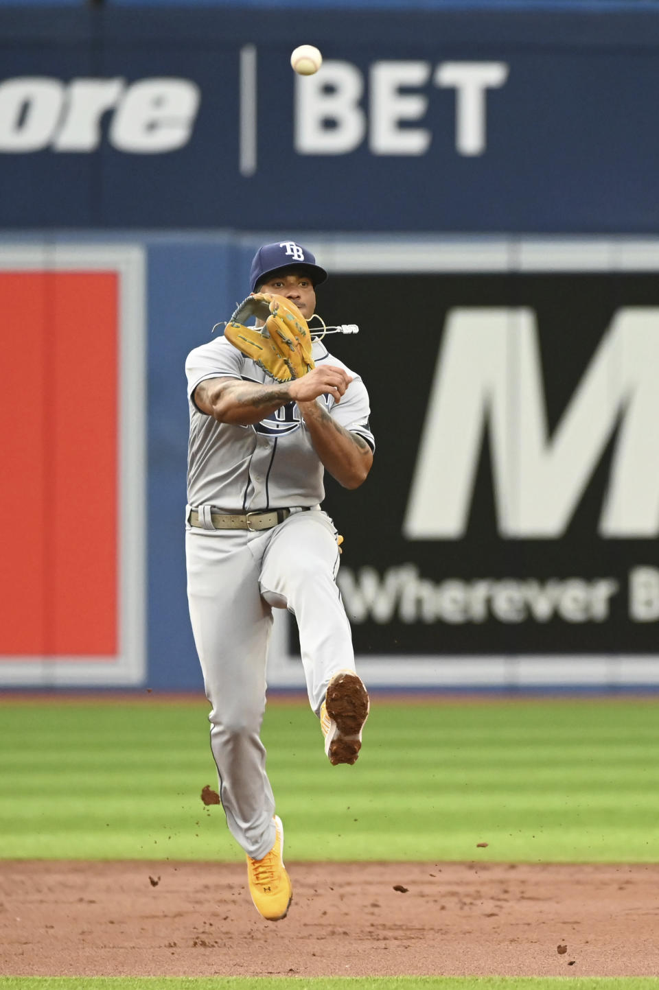 Tampa Bay Rays shortstop Wander Franco throws to first base to put out Toronto Blue Jays' Santiago Espinal during the second inning of a baseball game Thursday, June 30, 2022, in Toronto. (Jon Blacker/The Canadian Press via AP)