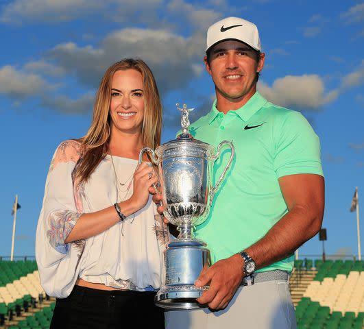 Richard Heathcote/Getty Brooks Koepka of the United States poses with the winner's trophy with Jena Sims after his victory at the 2017 U.S. Open at Erin Hills on June 18, 2017 in Hartford, Wisconsin