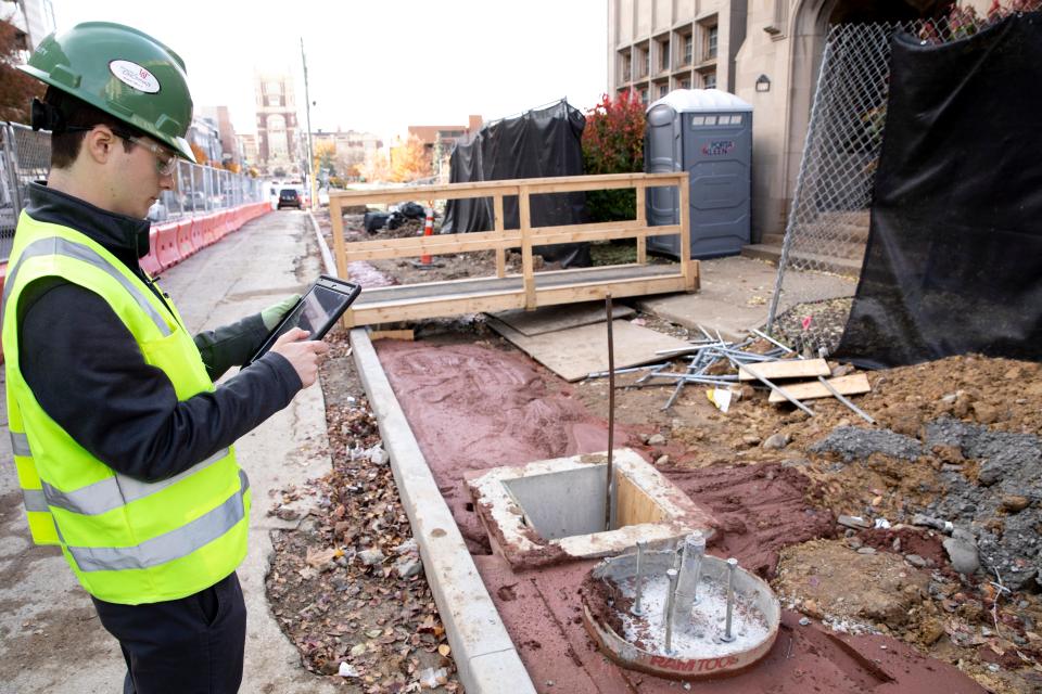 Tyler Wirth, a University of Cincinnati sophomore who works as a project engineer for Messer Construction through the UC cooperative program, takes an image of a safety concern while doing a safety inspection of a Messer construction site on the UC  campus on Tuesday, Nov. 16, 2021. Wirth is in his second co-op work semester at UC. Wirth's duties at Messer include making safety checks of a construction site.