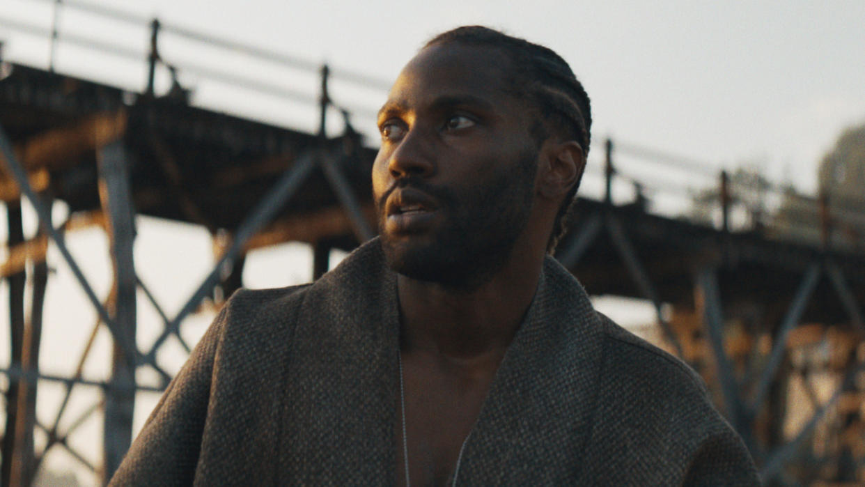  John David Washington looks cryptically off to the distance in The Creator. 