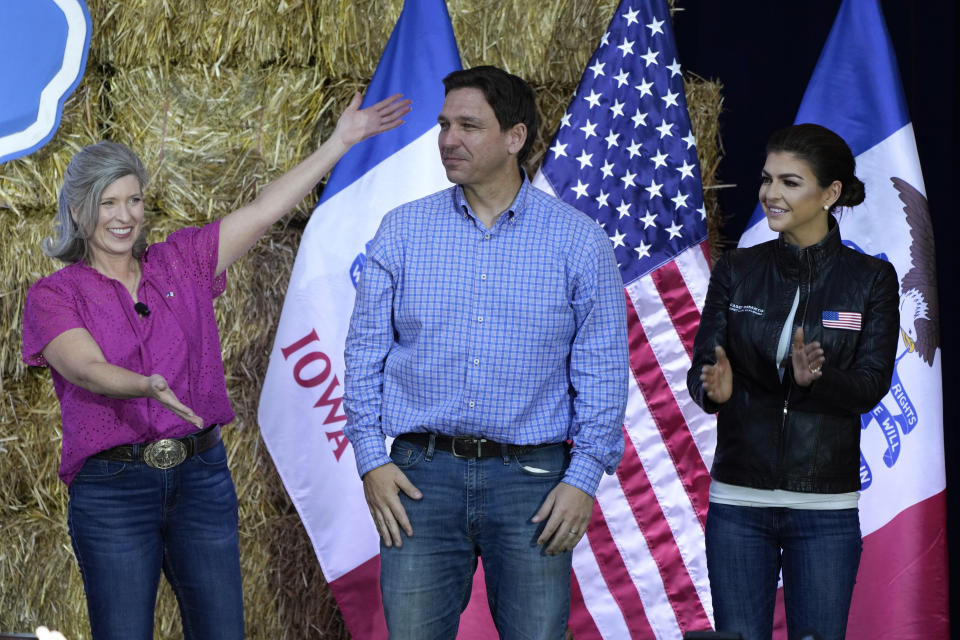 Republican presidential candidate and Florida Gov. Ron DeSantis stands on stage with his wife, Casey, right, and U.S. Sen. Joni Ernst, R-Iowa, during Ernst's Roast and Ride, Saturday, June 3, 2023, in Des Moines, Iowa. (AP Photo/Charlie Neibergall)