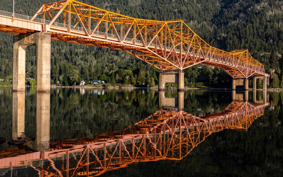 The Big Orange Bridge at Nelson is reflected in the Kootenay River