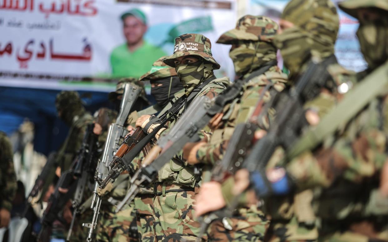 Members of Izz ad-Din al-Qassam Brigades, the military wing of Hamas, stand guard during a memorial ceremony for scholar Fadi al-Batsh  - Anadolu