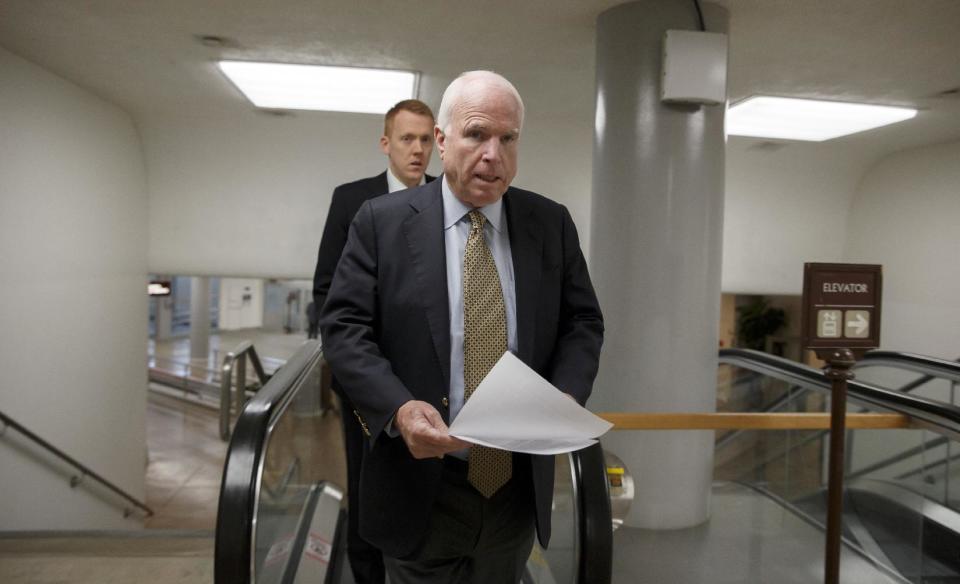 Sen. John McCain, R-Ariz., a member of the Senate Foreign Relations Committee, heads to the chamber to advance a bill providing $1 billion in loan guarantees to Ukraine as President Barack Obama meets with U.S. allies in Europe to punish Moscow for its annexation of the Crimean peninsula, at the Capitol in Washington, Monday, March 24, 2014. (AP Photo/J. Scott Applewhite)