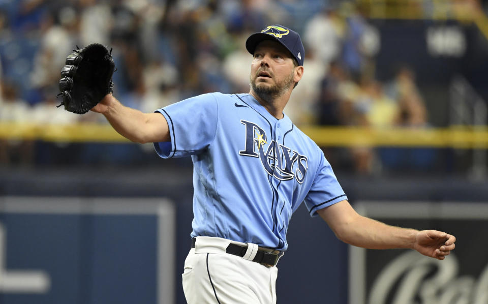 Tampa Bay Rays starter Rich Hill reaches for a new baseball after Toronto Blue Jays' Danny Jansen hit a solo home run during the third inning of a baseball game Sunday, July 11, 2021, in St. Petersburg, Fla.(AP Photo/Steve Nesius)