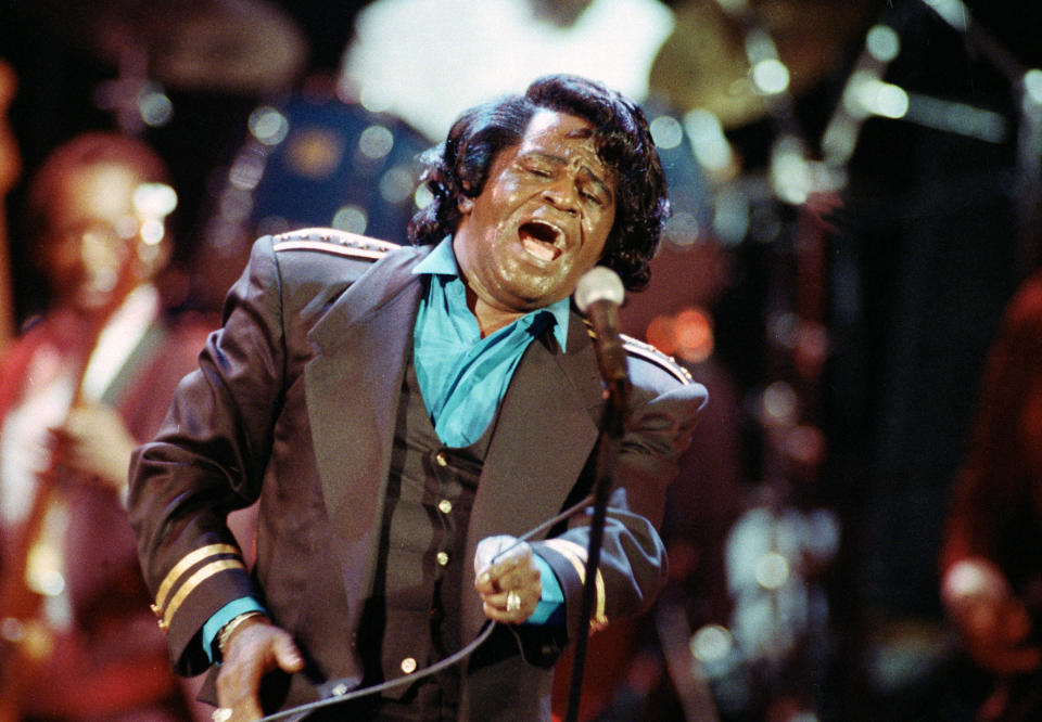 FILE - In this Monday, June 10, 1991 file photo, James Brown sings "Living in America" during his three-hour concert at the Wiltern Theater in Los Angeles. The family of entertainer James Brown has reached a settlement ending a 15-year battle over late singer’s estate. David Black, an attorney representing Brown’s estate, confirmed to The Associated Press on Friday, July 23, 2021 that the agreement was reached July 9. (AP Photo/Kevork Djansezian, File)