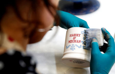 A worker prints a design onto a souvenir mug to commemorate the wedding of Britain's Prince Harry and Meghan Markle at the Emma Bridgewater Factory, in Hanley, Stoke-on-Trent, Britain March 28, 2018. REUTERS/Carl Recine