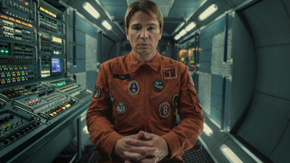 Josh Hartnett sits stoically in the spacecraft, hands folded, in Black Mirror: Beyond The Sea.