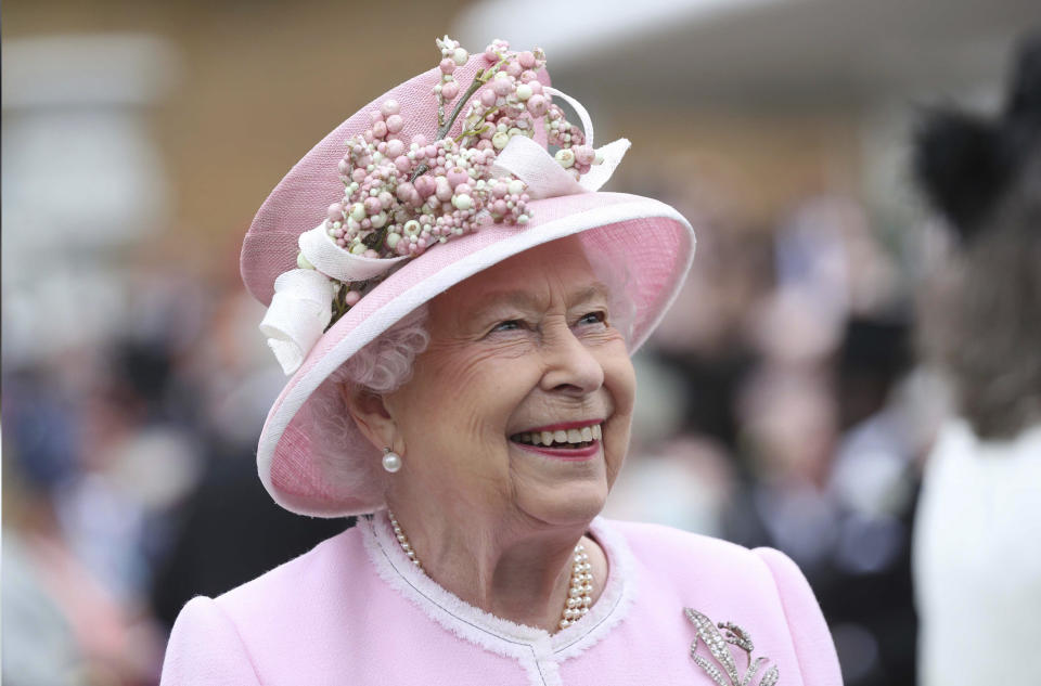 Dressed in pink and white suiting and a pink and white hat with blossom decorations, Her Majesty Queen Elizabeth II turns 96 years of age. Queen Elizabeth II during a garden party at Buckingham Palace on May 29, 2019 in London, England, UK.