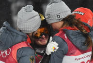 <p>Germany’s Katharina Althaus is comforted by fellow compatriots as she reacts to winning the silver medal in the women’s normal hill individual ski jumping trial for competition event during the Pyeongchang 2018 Winter Olympic Games on February 12, 2018, in Pyeongchang. / AFP PHOTO / Christof STACHE </p>