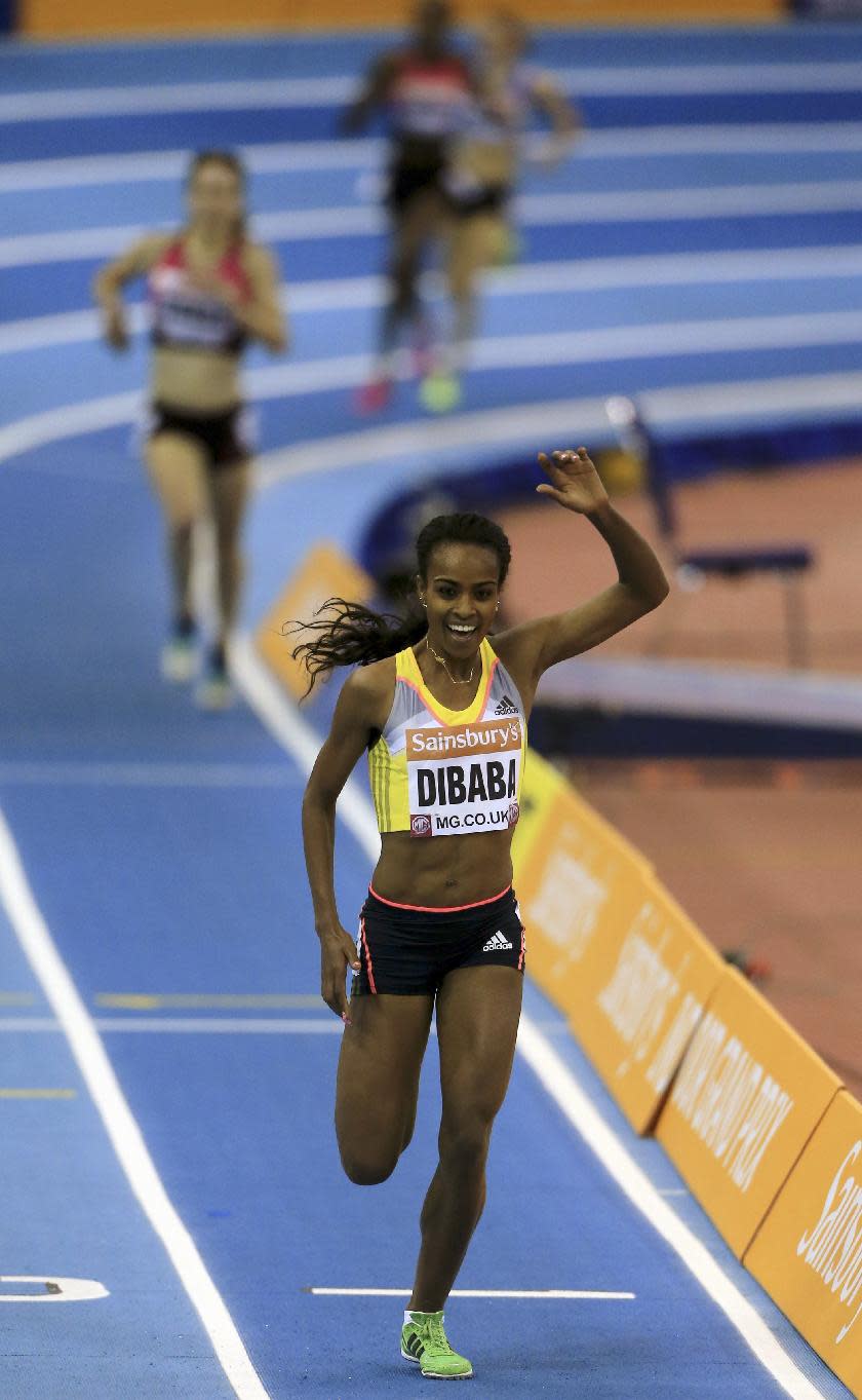 Genzebe Dibaba of Ethiopia, celebrates winning the Women's Two mile event in a new Indoor World Record time, during the British Athletics Indoor Grand Prix at the National Indoor Arena, Birmingham. England, Saturday Feb. 15, 2014. Dibaba set her third world record of the month by winning the two mile race in 9 minutes, 0.48 seconds. (AP Photo / Nick Potts, PA) UNITED KINGDOM OUT - NO SALES - NO ARCHIVES
