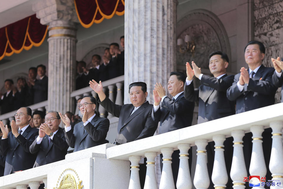 In this photo provided by the North Korean government, North Korean leader Kim Jong Un, center, waves from balcony as he attends a parade to celebrate the 110th birth anniversary of its late founder Kim Il Sung, at the Kim Il Sung Square in Pyongyang, North Korea Friday, April 15, 2022. Independent journalists were not given access to cover the event depicted in this image distributed by the North Korean government. The content of this image is as provided and cannot be independently verified. Korean language watermark on image as provided by source reads: "KCNA" which is the abbreviation for Korean Central News Agency. (Korean Central News Agency/Korea News Service via AP)