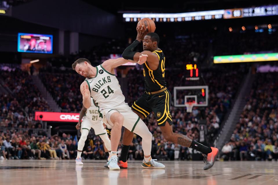 Golden State forward Jonathan Kuminga is called for an offensive foul after running into Milwaukee guard Pat Connaughton on March 6 at the Chase Center in San Francisco.