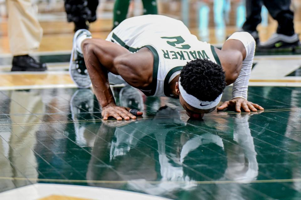 Michigan State senior Tyson Walker kisses the Spartans logo at mid-court during the senior night celebration after the game against Northwestern on Wednesday, March 6, 2024, at the Breslin Center in East Lansing.