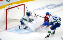 Montreal Canadiens' Ryan Poehling scores past Vancouver Canucks goaltender Thatcher Demko as Canucks' Bo Horvat (53) looks on during the first period of an NHL hockey game, Monday, Nov. 29, 2021 in Montreal. (Paul Chiasson/The Canadian Press via AP)