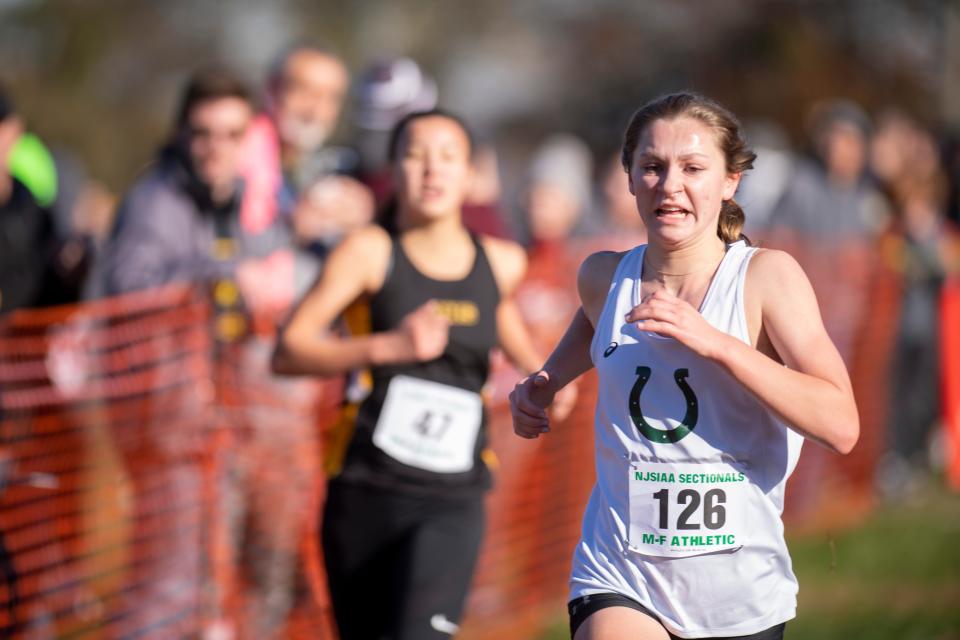 NJSIAA North 1 cross country sectional championships at Garret Mountain Reservation in Woodland Park on Saturday, November 6, 2021. Grace Mougalian, of Kinnelon, on her way to finishing first in the Group 1 Girls race. 