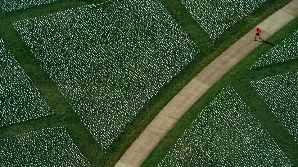 People visit the 'In America: Remember' public art installation near the Washington Monument on the National Mall in Washington, DC, on September 20, 2021. - Kent Nishimura/Los Angeles Times/Getty Images