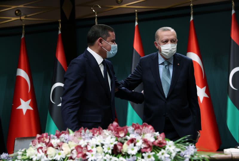 Turkish President Erdogan and Libyan PM Dbeibeh leave after a news conference in Ankara