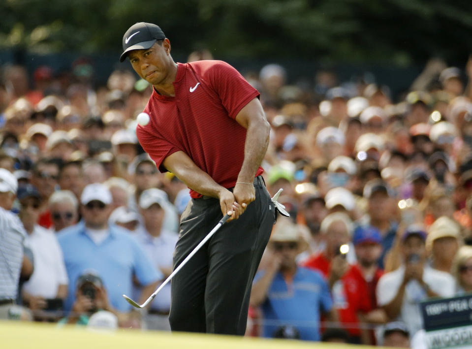 Tiger Woods chips onto 14th green during the final round of the PGA Championship golf tournament at Bellerive Country Club, Sunday, Aug. 12, 2018, in St. Louis. (AP Photo/Charlie Riedel)