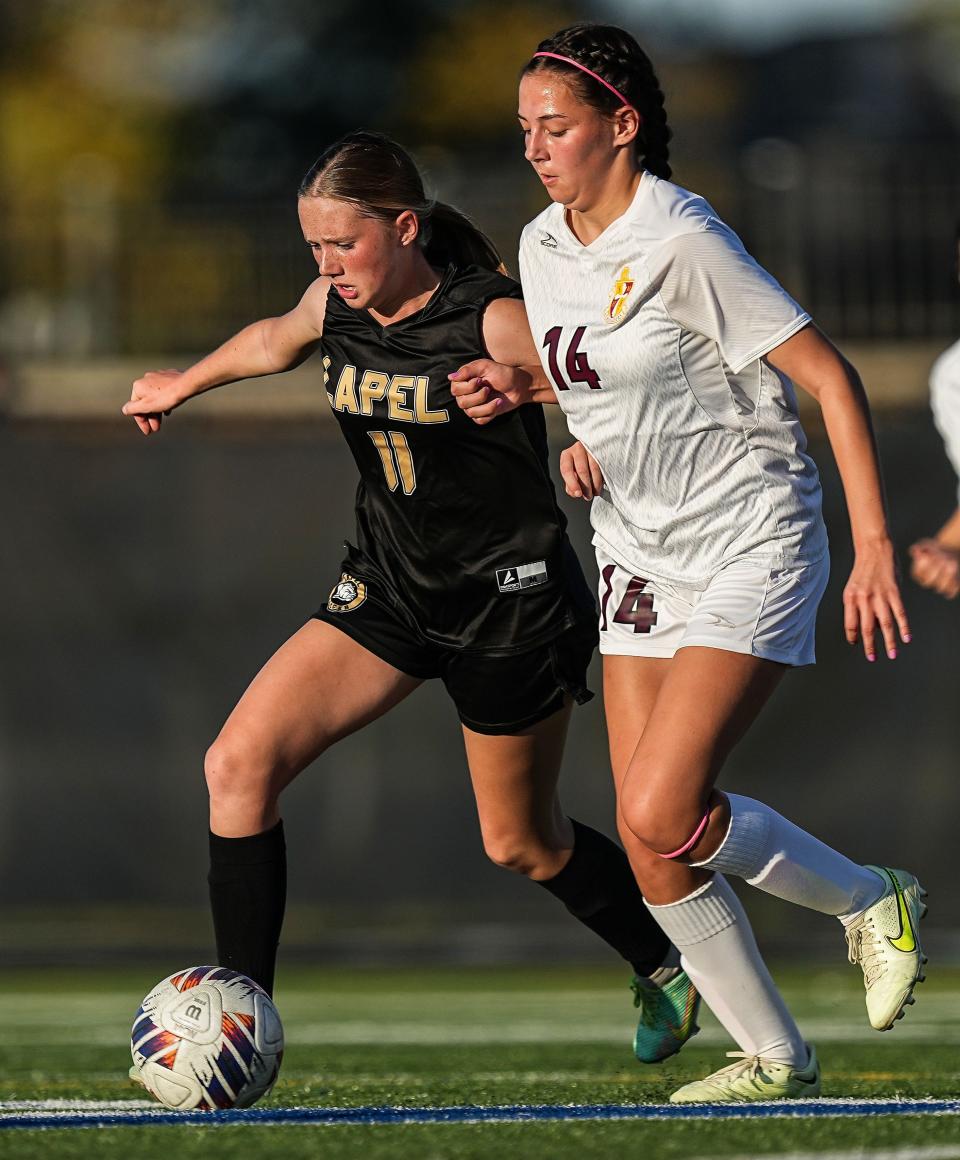 Lapel Bulldogs midfielder Leila Wilson (11) battles for the ball against Scecina Crusaders midfielder Brooklyn Drewes (14) on Tuesday, Oct. 3, 2023, during the IHSAA sectional semifinals at Heritage Christian High School in Indianapolis. The Lapel Bulldogs defeated the Scecina Crusaders, 6-2.