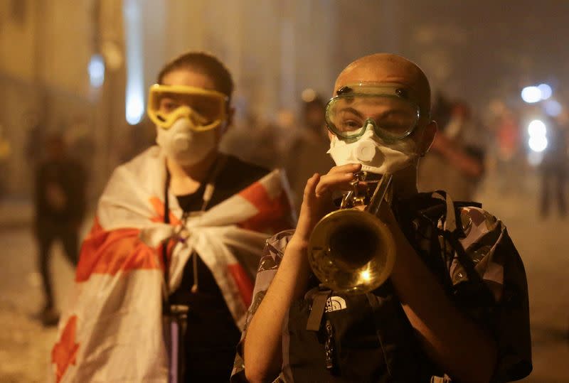 FILE PHOTO: Demonstrators hold a rally to protest against a bill on "foreign agents", in Tbilisi