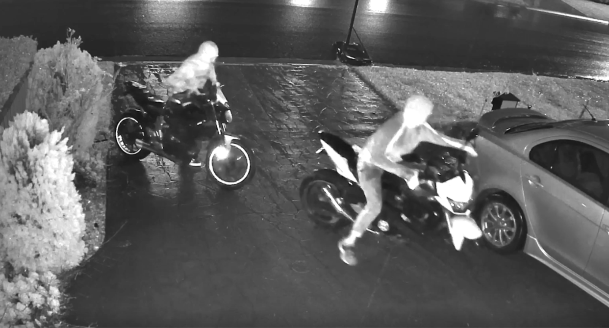 Two hooded figures are seen on a CCTV still attempting to steal two motorbikes as vehicle theft soars across Australia. 