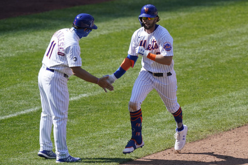 New York Mets third base coach Tony DeFrancesco congratulates Jeff McNeil (6) as McNeil trots the bases after hitting a solo home run during the sixth inning of a baseball game against the Philadelphia Phillies, Sunday, Sept. 6, 2020, in New York. (AP Photo/Kathy Willens)