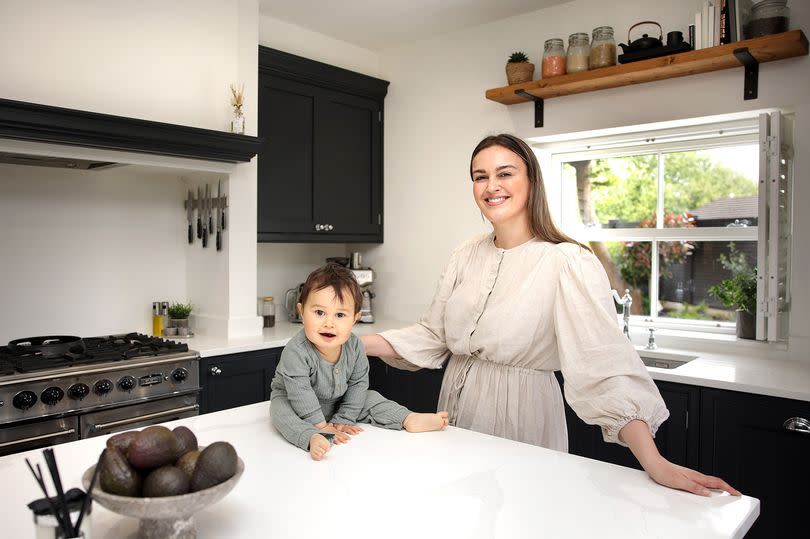 Roxy and her son in their home, which is now on the market -Credit:Sean Hansford | Manchester Evening News