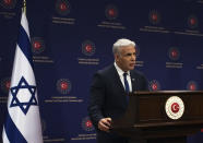 Israeli Foreign Minister Yair Lapid speaks to the media during a joint news conference with Turkish Foreign Minister Mevlut Cavusoglu, in Ankara, Turkey, Thursday, June 23, 2022. Lapid on Thursday thanked Turkish authorities for their cooperation in allegedly foiling attacks against Israeli citizens in Turkey and warned Israel would not "sit idly-by " in the face of threats to its citizens from Iran. (AP Photo/Burhan Ozbilici)