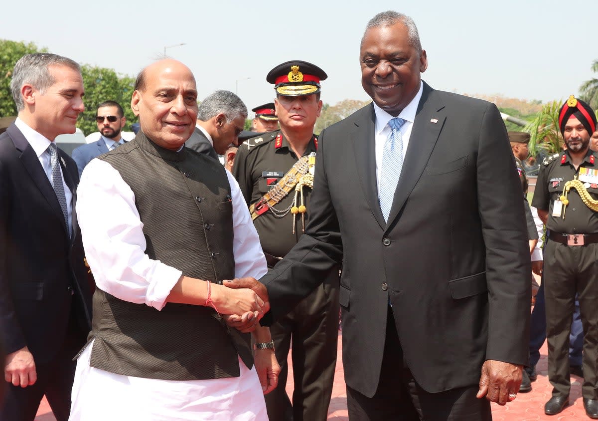 US Defence Secretary Lloyd Austin (R) shake hands with Indian Defence Minister Rajnath Singh during a ceremonial welcome ceremony (EPA)