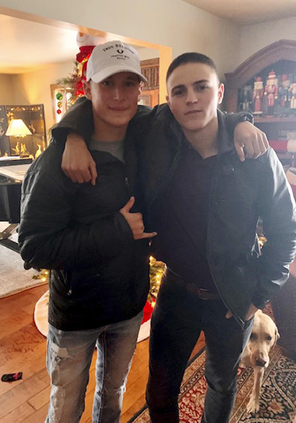 This Dec. 2019, photo provided by Regi Stone shows Eli Stone, left, and Rylee McCollum, at Christmas in Stone's house in Jackson, Wyo. Rylee McCollum, of Bondurant, Wyo., was one of the U.S. Marines killed in the suicide bombing at the Kabul airport, in Afghanistan, according to his sister, Roice McCollum. (Regi Stone via AP)