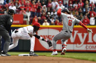 Cincinnati Reds third baseman Elly De La Cruz, left, tags Washington Nationals designated hitter Jesse Winker (6) as he attempts to reach second during the first inning of an opening day baseball game in Cincinnati, Thursday, March 28, 2024. (AP Photo/Timothy D. Easley)