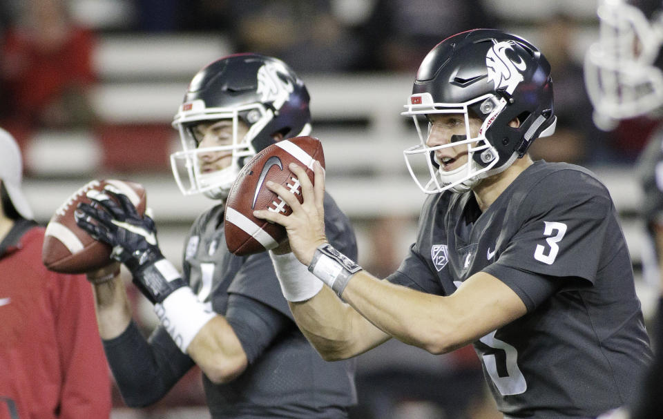 Washington State quarterbacks Tyler Hilinski (3) and Luke Falk take snaps during warmups before an NCAA college football game against Southern California in Pullman, Wash., Friday, Sept. 29, 2017. (AP Photo/Young Kwak)