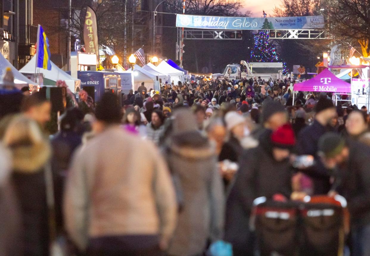 Crowds fill Main Street before a path forms to welcome the arrival of Santa and Mrs. Claus at the Brighton Holiday Glow on Saturday, Nov. 20, 2021.