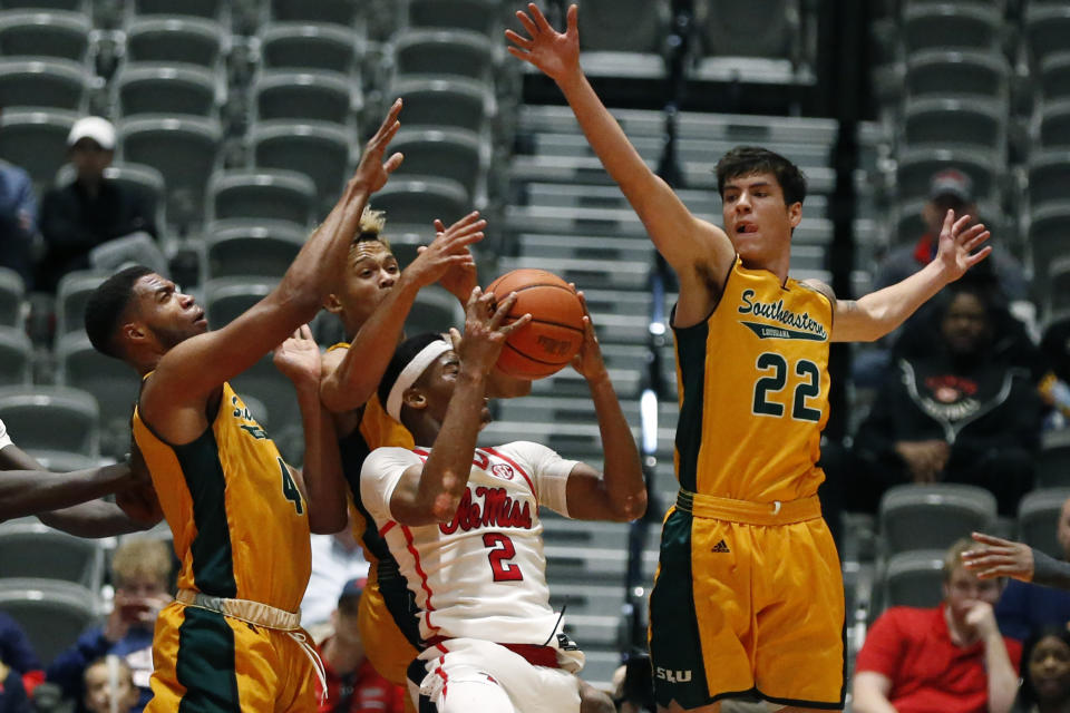 Southeastern Louisiana forward Nick Caldwell (22) and teammates defend against a shot by Mississippi guard Devontae Shuler (2) during the second half of an NCAA college basketball game, Saturday, Dec. 21, 2019, in Jackson, Miss. Mississippi won 83-76.(AP Photo/Rogelio V. Solis)