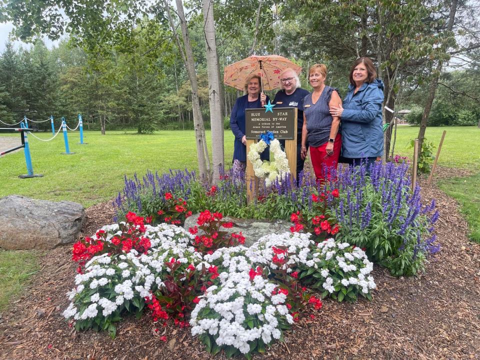Somerset Garden Club members, left to right, Marge McCune, Jan Szych, Linda Musser and Deb Stutzman stand for a photo at the Blue Star Memorial By-Way Marker at Patriot Park.