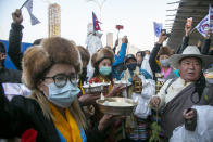 Friends and family members wait to receive the all-Nepalese mountaineering team that became the first to scale Mount K2 in winter as they arrive at Tribhuwan International airport in Kathmandu, Nepal, Tuesday, Jan. 26, 2021. (AP Photo/Niranjan Shrestha)