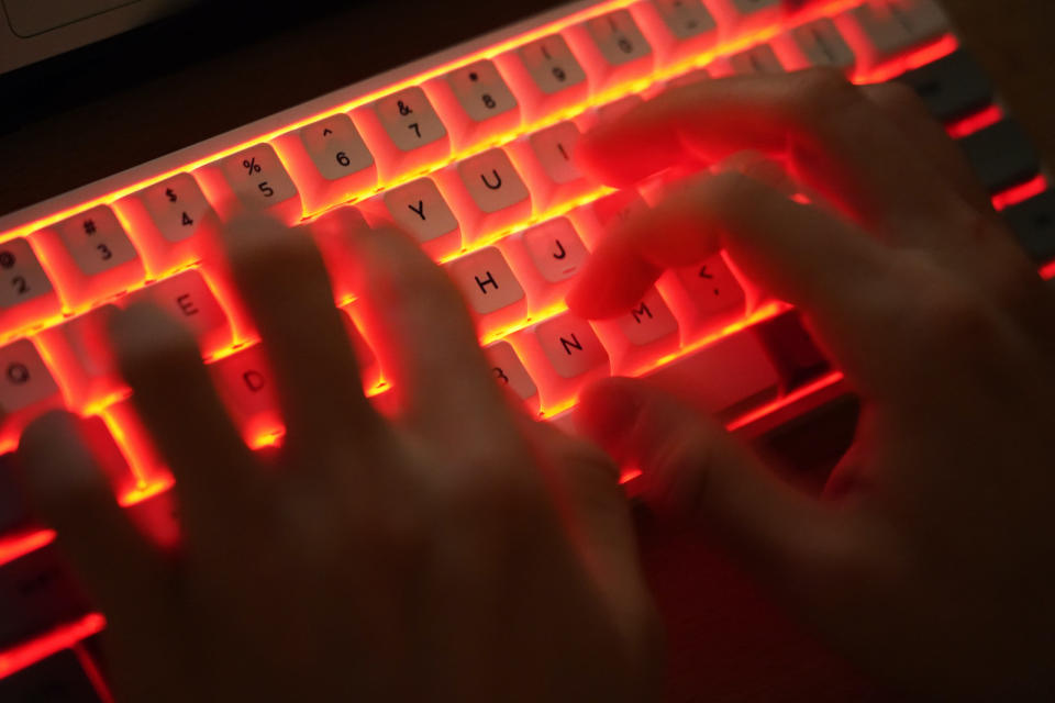 BERLIN, GERMANY - JANUARY 25: In this photo illustration a young man types on an illuminated computer keyboard typically favored by computer coders on January 25, 2021 in Berlin, Germany. 2020 saw a sharp rise in global cybercrime that was in part driven by the jump in online retailing that ensued during national lockdowns as governments sought to rein in the coronavirus pandemic. (Photo by Sean Gallup/Getty Images)