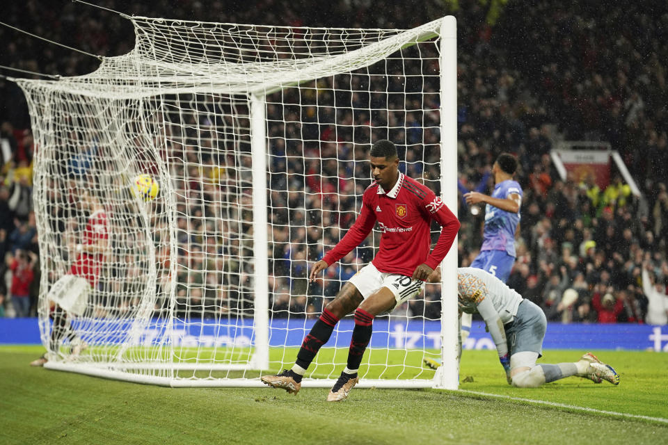 Manchester United's Marcus Rashford, centre, celebrates after scoring his side's third goal during the English Premier League soccer match between Manchester United and Bournemouth at Old Trafford in Manchester, England, Tuesday, Jan. 3, 2023. (AP Photo/Dave Thompson)