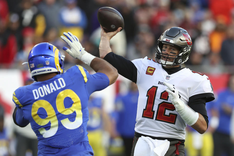 Los Angeles Rams defensive end Aaron Donald (99) tries to block a pass by Tampa Bay Buccaneers quarterback Tom Brady (12) during the second half of an NFL divisional round playoff football game Sunday, Jan. 23, 2022, in Tampa, Fla. (AP Photo/Mark LoMoglio)