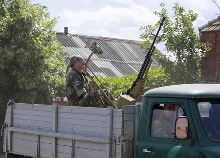 Pro-Russian separatists drive a truck in the direction of the battle line in Seversk (Siversk), located near the town of Krasny Liman, Donetsk region, June 19, 2014. REUTERS/Shamil Zhumatov