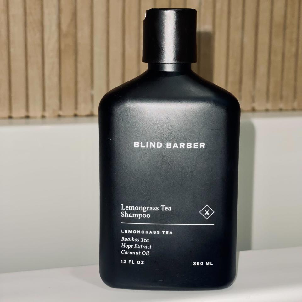 blind barber shampoo on white porcelain with tile background with wood slat background