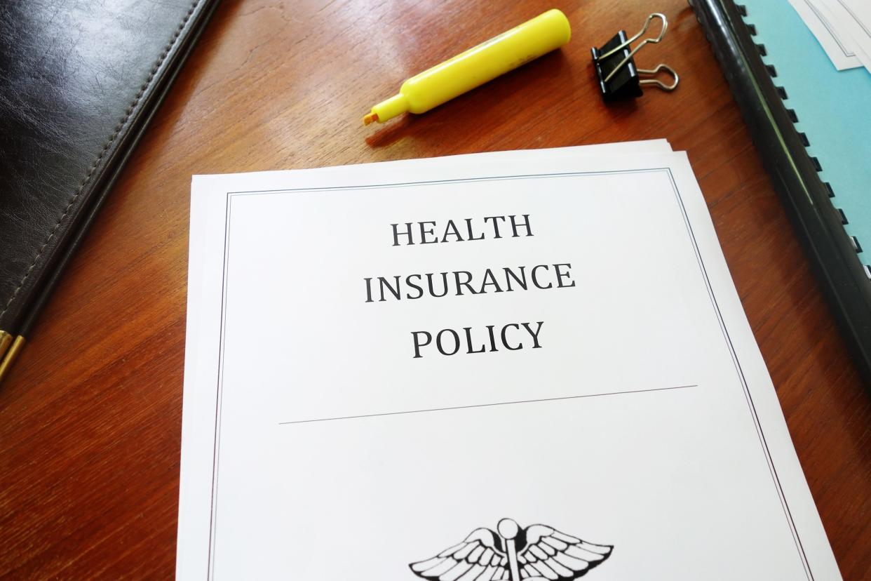 Health Insurance Policy on an office desk