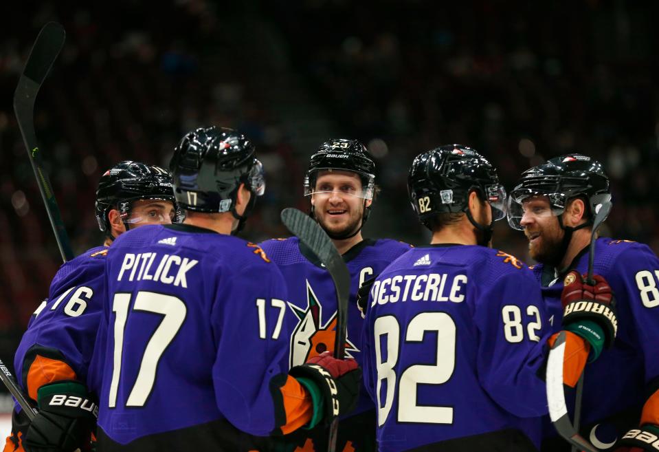 Feb. 20, 2021; Glendale, Arizona, USA; Coyotes' Oliver Ekman-Larsson (23) celebrates with teammates Derick Brassard (16), Tyler Pitlick (17), John Oesterle (82) and Phil Kessel after Brassard scores a goal against the Kings during the second period at Gila River Arena.