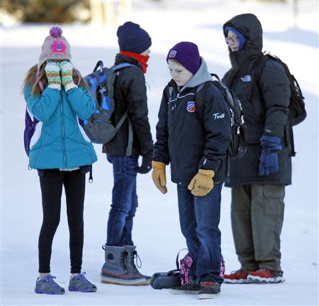 Students wait for their school bus in a sub-zero temperature in Minneapolis, January 8, 2014. REUTERS/Eric Miller