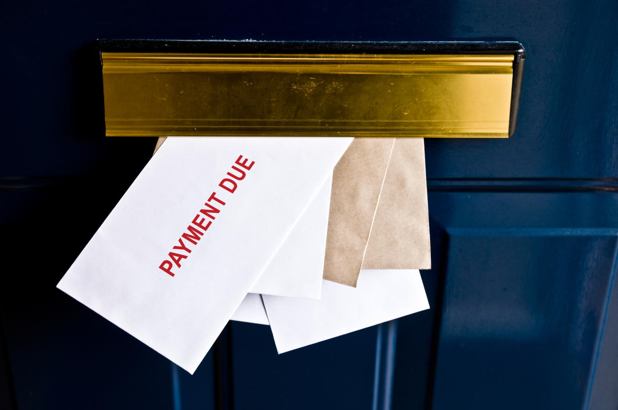 Letters in letterbox saying payment due