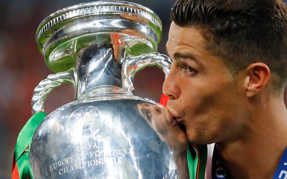 Cristiano Ronaldo kisses the trophy at the end of the Euro 2016 final