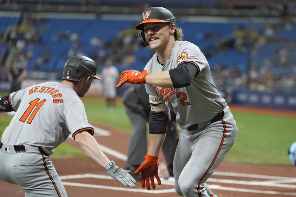 Baltimore Orioles' Gunnar Henderson (2) celebrates with Jordan Westburg (11) after Henderson hit a leadoff home run off Tampa Bay Rays starting pitcher Ryan Pepiot during the first inning of a baseball game Monday, June 10, 2024, in St. Petersburg, Fla. (AP Photo/Chris O'Meara)
